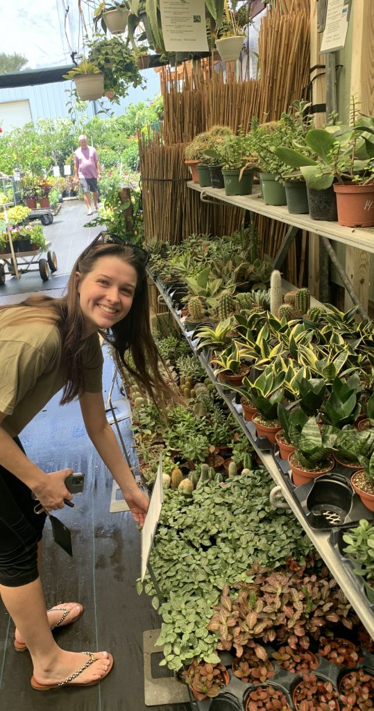 UF sustainability student posing with plants
