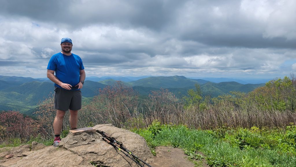 UF professor of Environmental Science, Danny Coenen, stands in the mountains. 