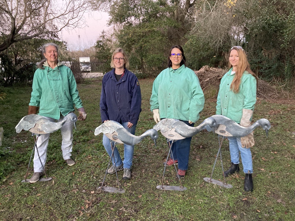 Women with metal cranes