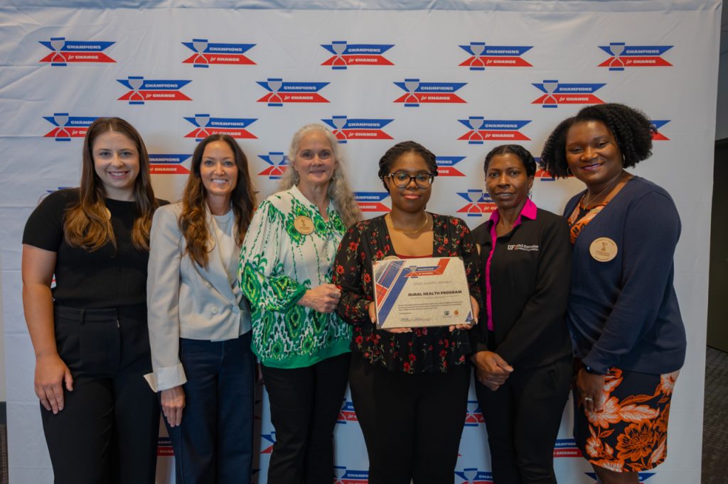 2025 Champions for Change Award Recipients, Rural Health Program, pose with their award certificate.