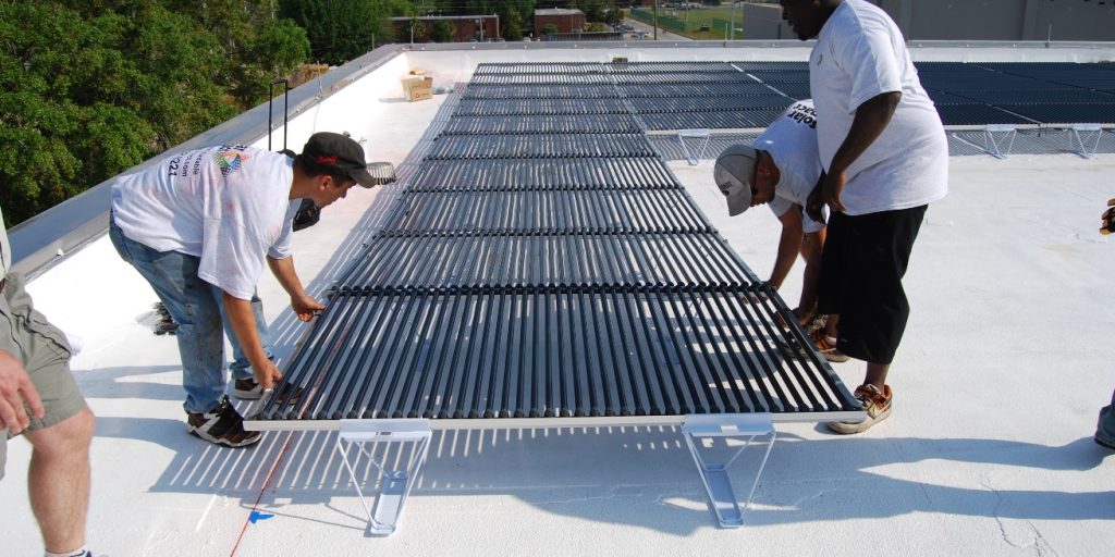 Construction team place down thermal solar coils