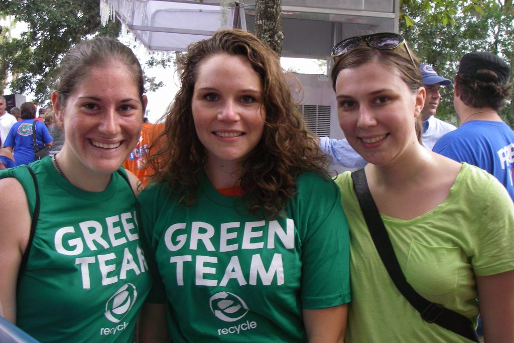 Green Team students smile at the camera, wearing 