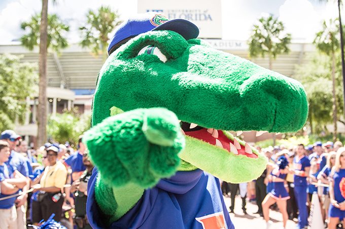 Albert the Gator posing by pointing at the camera in front of the Ben Hill Griffin Stadium