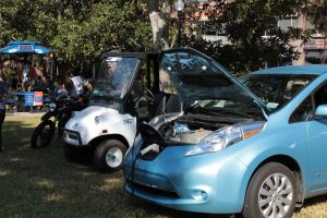 Electric cars parked with their hoods open at the Sustainable Transportation Fair