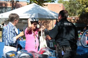 Police hand out helmets at the Sustainable Transportation Fair