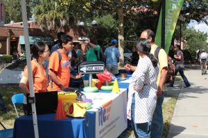 People stopping by tables at the Sustainable Transportation Fair