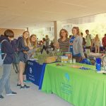 Field and Fork Farm and Pantry tabling during the Sustainability Showcase, with fresh fruits and vegetables displayed at their table