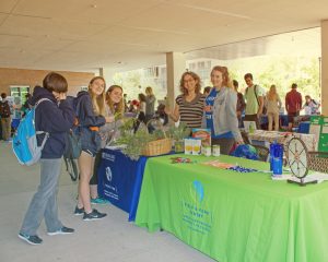 Field and Fork Farm and Pantry tabling during the Sustainability Showcase, with fresh fruits and vegetables displayed at their table