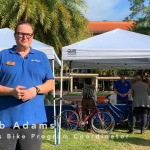 Jacob Adams, Campus Bike Program Coordinator, stands in front of his stand at the Sustainable Transportation Fair