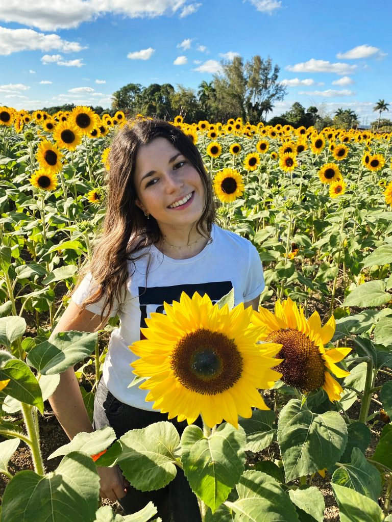 UF student Gali Polichuk with sunflowers.