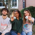 UF student interns holding buttons.