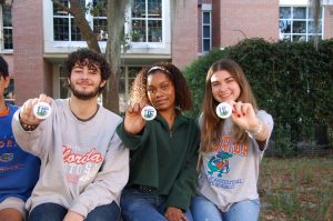UF student interns holding buttons.