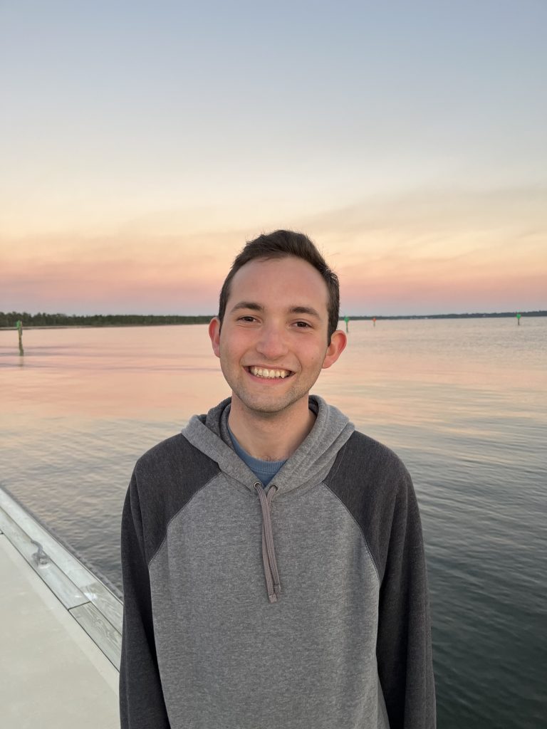 UF student David Flores by the water outdoors in a natural area. 