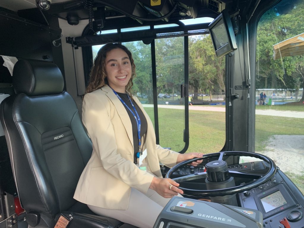 Valentina in the driver's seat of a small vehicle while working in the natural environment.