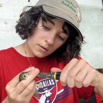 UF student Brynn Fricke with a bird at the banding lab.