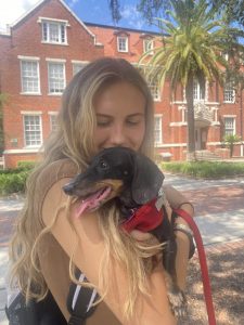 Kathryn Davis holds a puppy on the UF campus.